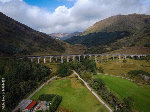 Scenic aerial view of Glenfinnan viaduct with train by autumn, Scotland