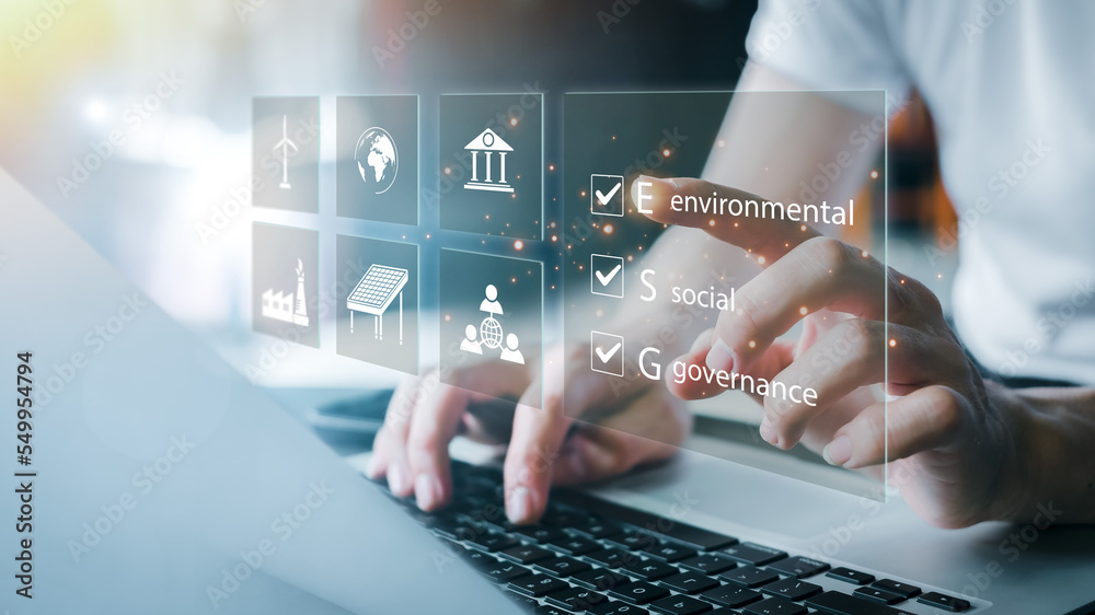 custom made wallpaper toronto digitalESG. environment social governance investment business concept. Businessmen use a computer to analyze ESG, surrounded by ESG icons close to the computer screen in business investment strategy concept.