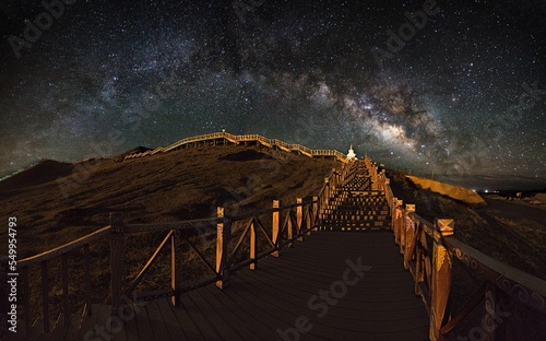 Fotografie, Tablou Milky Way over the wooden footbridge in Tibet, China