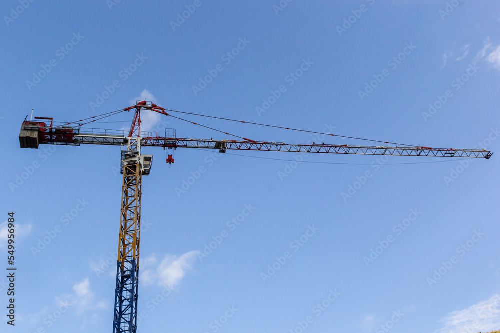 Tower cranes building a house. Concrete building under construction. Construction site Tower cranes building a house. Concrete building under construction. Construction site