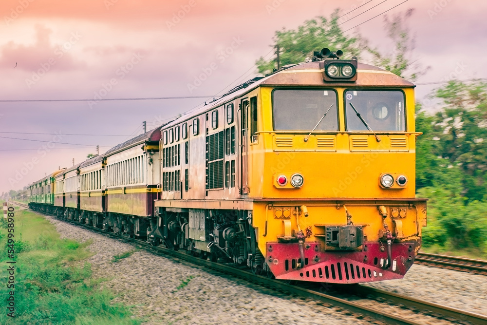 Passenger train by diesel locomotive on the railway.