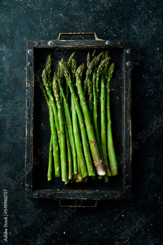 Organic food. Green asparagus in a wooden box. Top view.