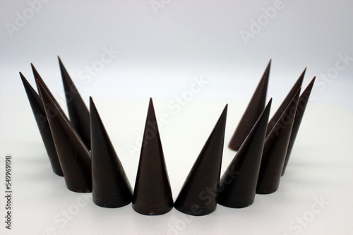 Elongated chocolates on white background