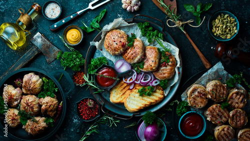 A set of fried meat, cutlets and shish kebab, handmade recipe. On a black stone background. Top view. © Yaruniv-Studio