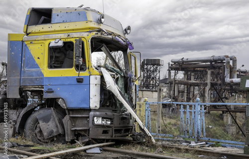 damaged and looted car and destroyed buildings of the workshop of the Azovstal plant in Mariupol
