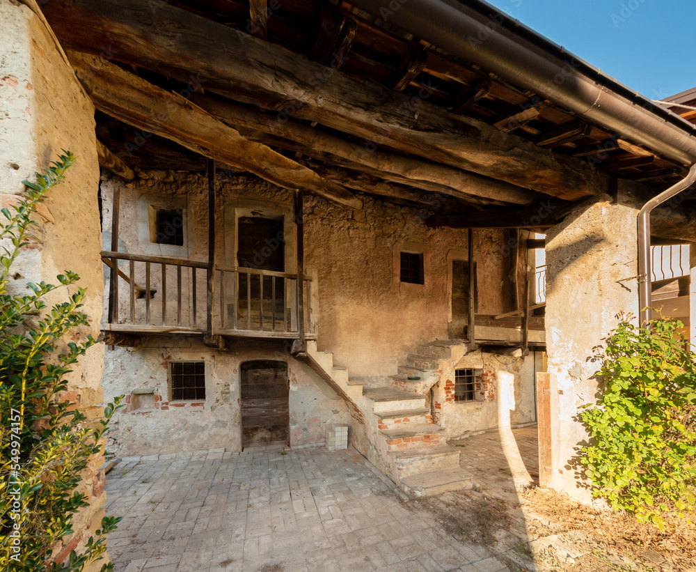 Old rustic mountain house with wooden balconies in Boves village in Piedmont, Italy