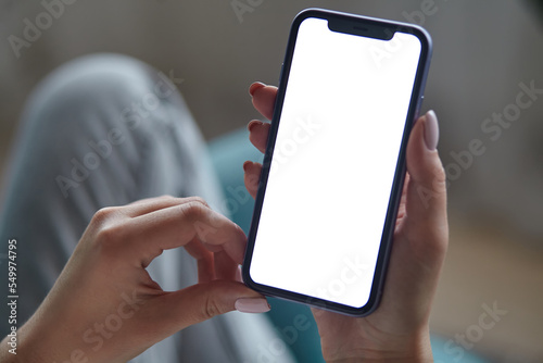 Close up Mock up white screen blank close up mobile phone in woman hands holding Back view