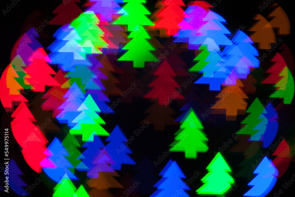 Christmas tree shape bokeh of colorful electric garland. The picture was taken with a shaped lens attachment Christmas tree shape bokeh of colorful electric garland. The picture was taken with a shaped lens attachment