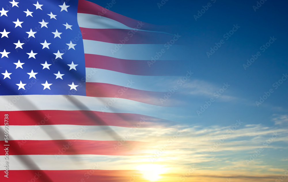 Fototapeta premium USA flag on background of sunset or sunrise. Greeting card for Veterans Day or Memorial Day