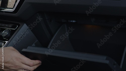 Close-up opening and closing a car glove compartment box. photo