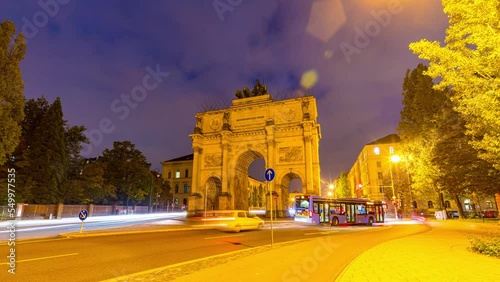 Sunset hyperlapse at The Siegestor Victory Arch in Munich City Bavaria with traffic. Day to night timelapse in 4K photo