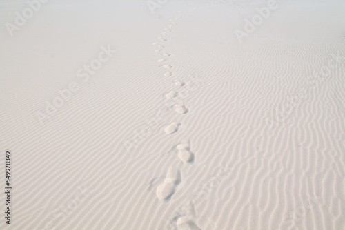 Footprints in the white sand. Huellas en la arena blanca photo