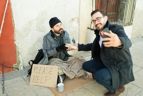 Caucasian man taking advantage of a poor man while doing charity