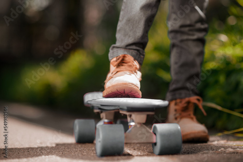 Close up picture of a kids hand holding a skateboard