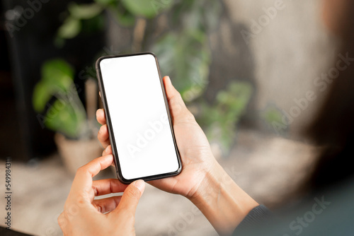 cell phone blank white screen mockup.hand holding texting using mobile on desk at office.background empty space for advertise.work people contact marketing business,technology