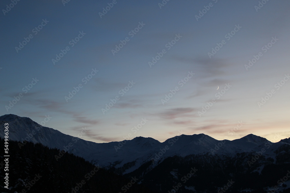 Silhouetted Swiss alps at Twilight. Alpine landscape wallpaper, background or screensaver with copy space (Verbier, Valais, Switzerland)
