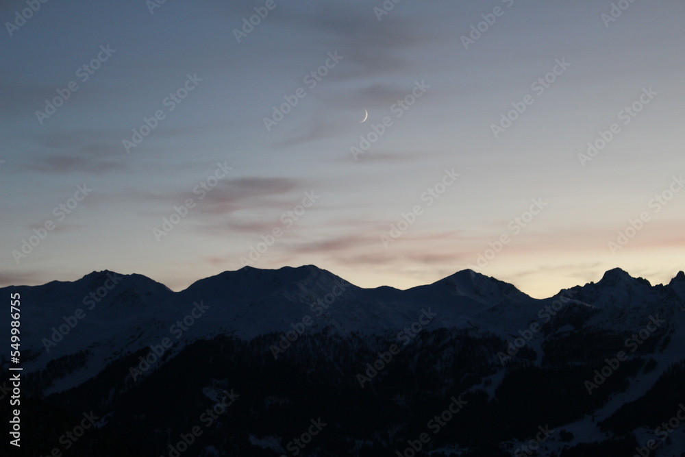 soft twilight with crescent moon over Swiss alps