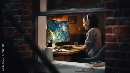 Cheerful Female Gamer Playing Online Video Game on Personal Computer. Professional Woman Player Enjoying Fantasy RPG. Real Role Playing Character Casting Magic Spells, Destroying Enemies. Window View.
