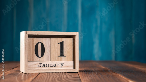 January First wooden vintage calendar on dark blue background.