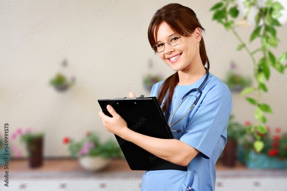 Fototapeta premium Young happy female doctor in clinic