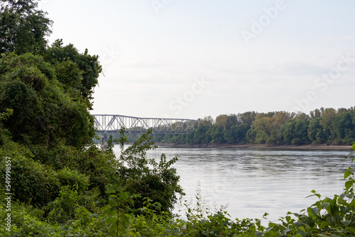 Bridge over river with trees and greenery