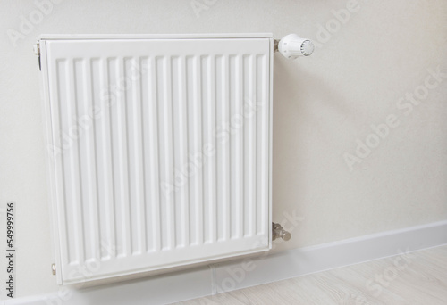 Modern wall mounted heating radiator in the room. Comfortable temperature in the apartment in winter. heating price. Copy space for text