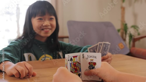 Asian teenage girl playing cards. Old Maid.