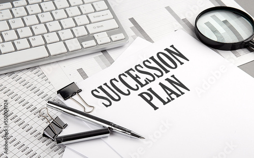 SUCCESSION PLAN text on paper with chart and keyboard, business concept