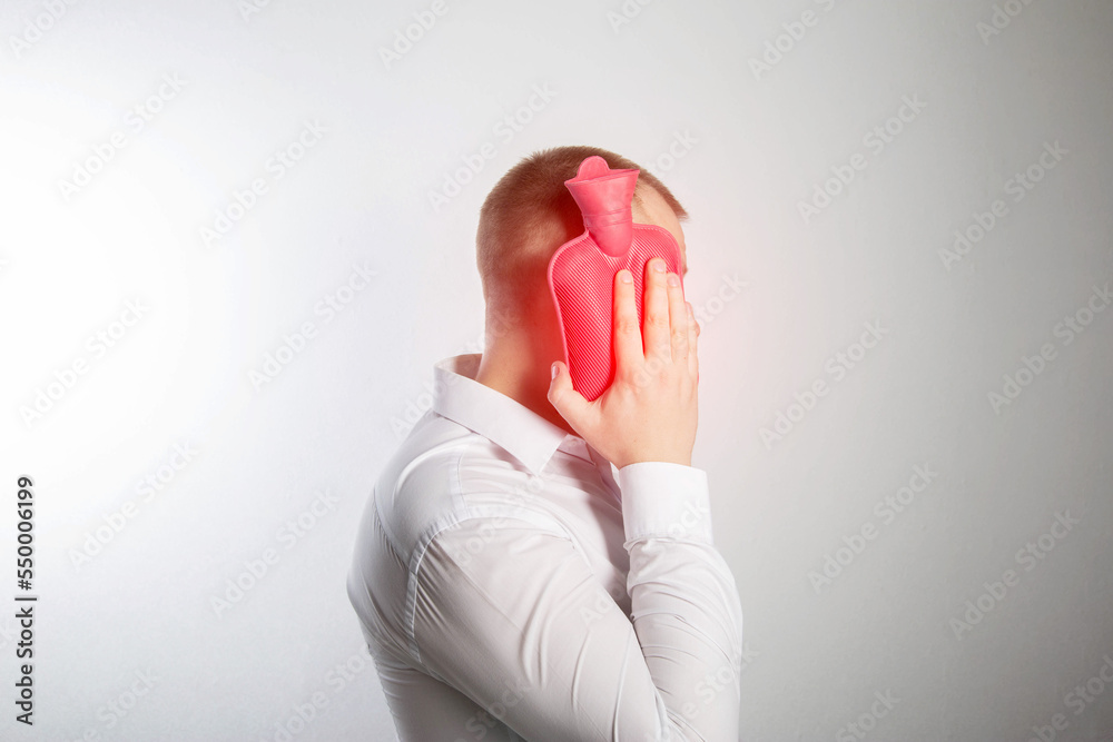 custom made wallpaper toronto digitalA man holds a heating pad with hot water near his cheek. Toothache, infection. Heat treatment. Close-up