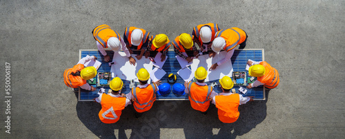 Canvas Print Top view of architectural engineering working on solar panels and his blueprints with Solar photovoltaic equipment on construction site