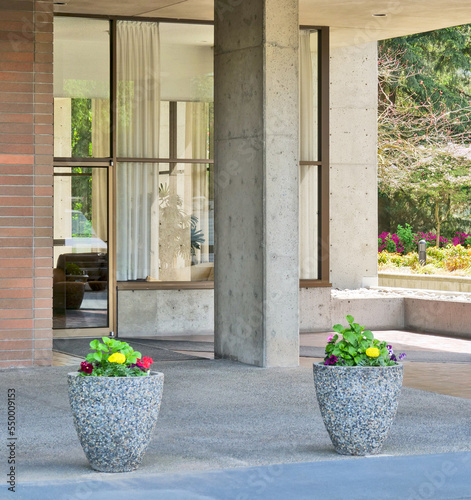 Two small flower beds in front of residential building entrace photo