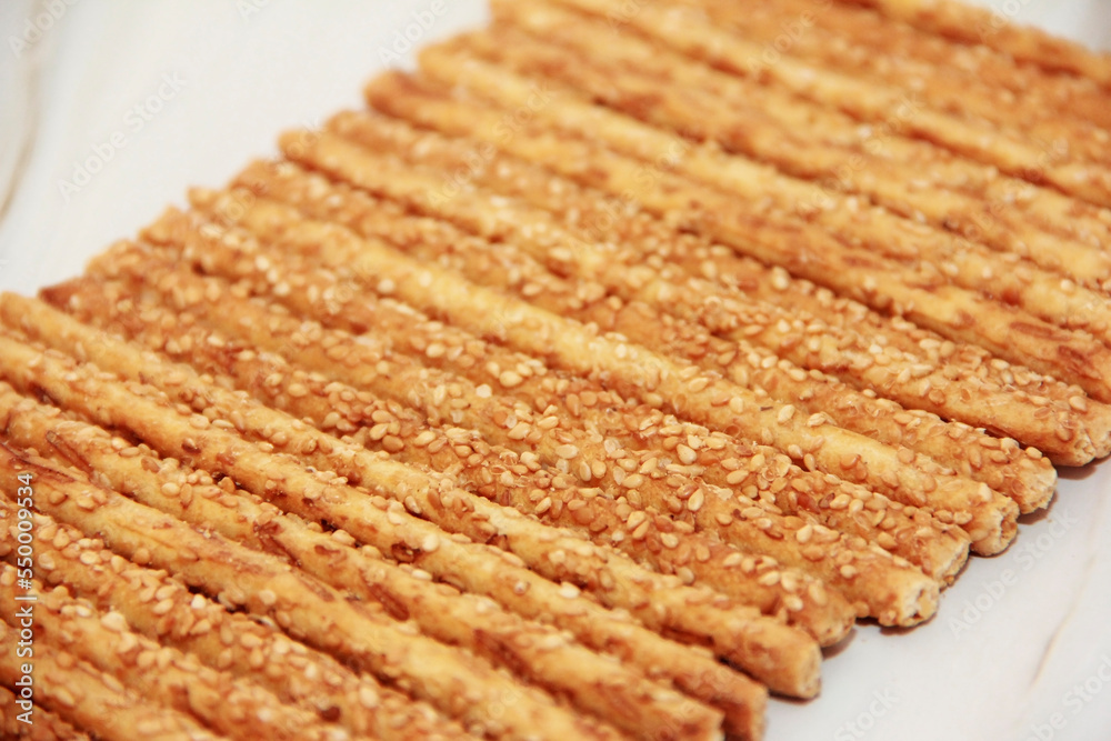 baked dry long bread sesame sticks on a marble background baked dry long bread sesame sticks on a marble background
