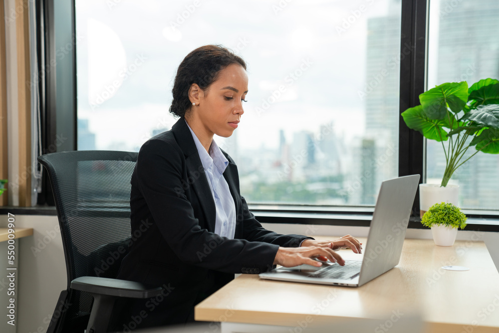 Successful businesswoman working at her office desk, Concept of business risk analysis and assessment Successful businesswoman working at her office desk, Concept of business risk analysis and assessment