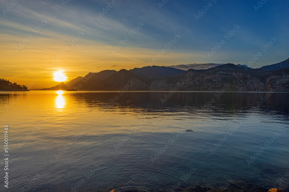 Lake Garda (Lago di Garda) and Italian Alps view from the small village of Malcesine at sunset, Verona province, Italy, Veneto, southern Europe. On background the coast of Lombardy.