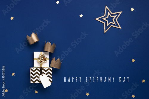 Three gold crowns for Traditional Three King's Day of January 6, blue background. photo