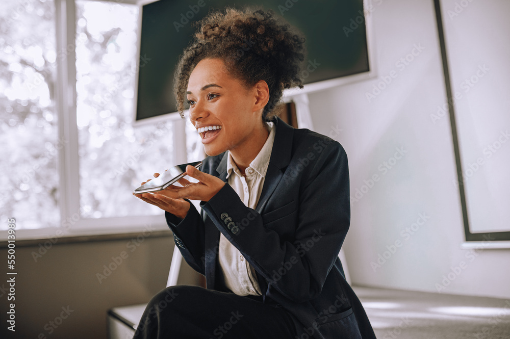 Woman holding smartphone at mouth level talking Woman holding smartphone at mouth level talking