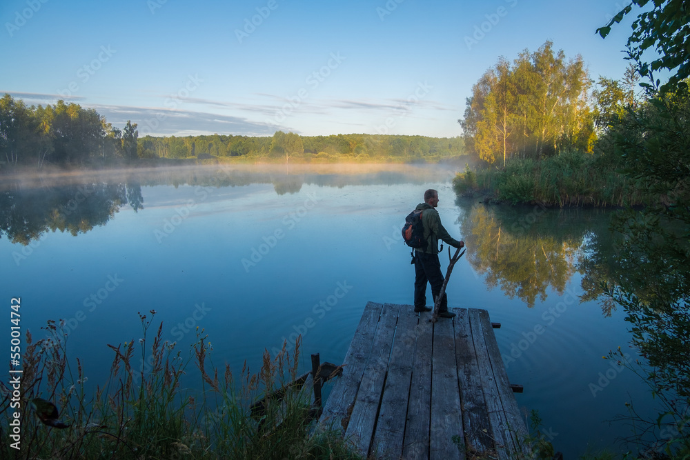 person on the morning lake
