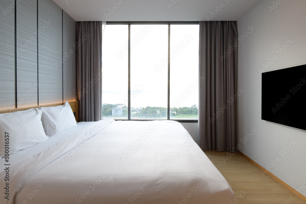 Fototapeta premium Warm and cozy interior of bedding room space with bed. Cozy home decor.