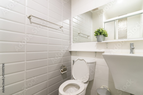 Loft white tile bathroom corner, tub and sink