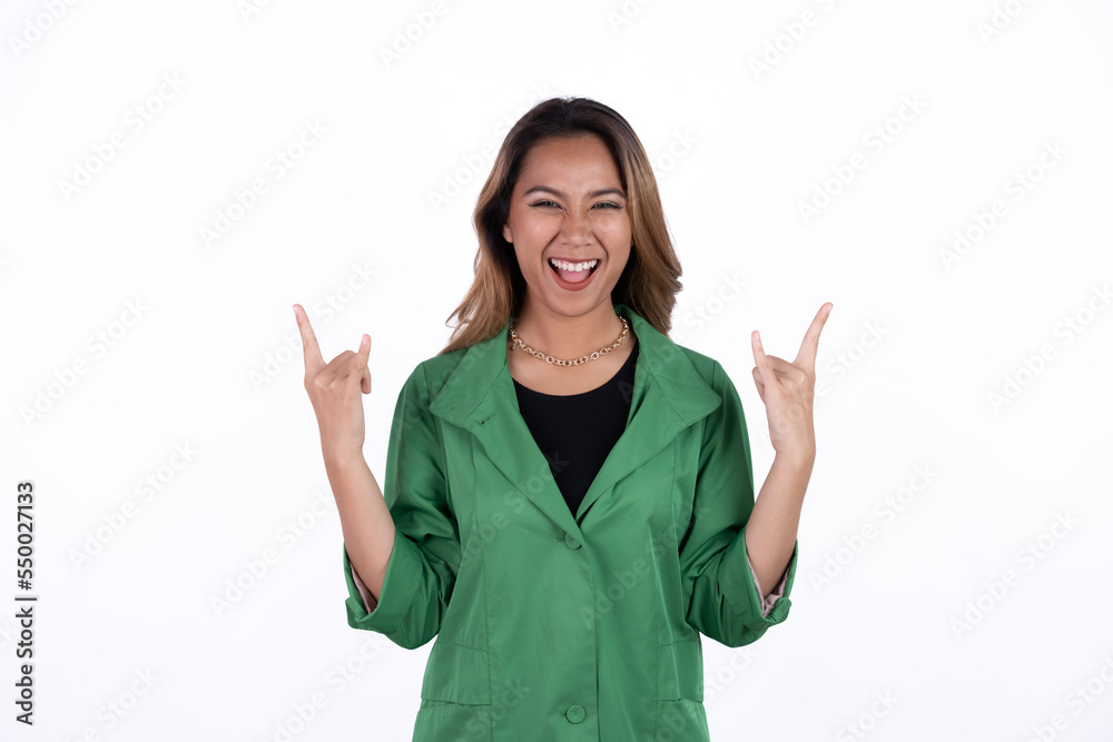 Rock n roll. Funny spanish woman in denim overalls, looking at camera with rock sing. Studio shot, on white background. Rock n roll. Funny spanish woman in denim overalls, looking at camera with rock sing. Studio shot, on white background.
