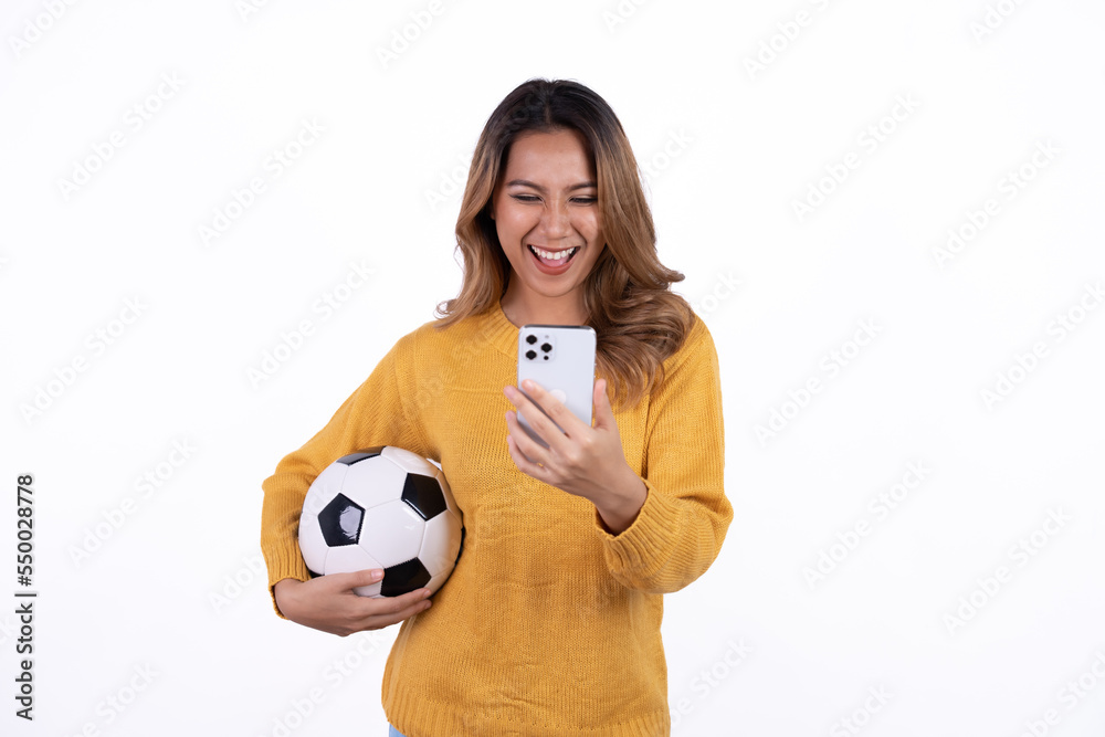 Happy Asian woman football fan cheer up support favorite team with soccer ball isolated on white background. Happy Asian woman football fan cheer up support favorite team with soccer ball isolated on white background.