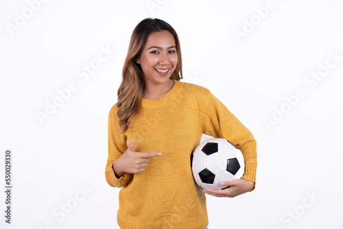 Happy Asian woman football fan cheer up support favorite team with soccer ball isolated on white background. © Parichat