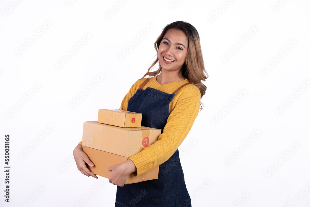 Young Asian woman startup small business freelance holding parcel box and sitting on isolated over the bright white color background, SME Online marketing packing box delivery and isolated concept Young Asian woman startup small business freelance holding parcel box and sitting on isolated over the bright white color background, SME Online marketing packing box delivery and isolated concept