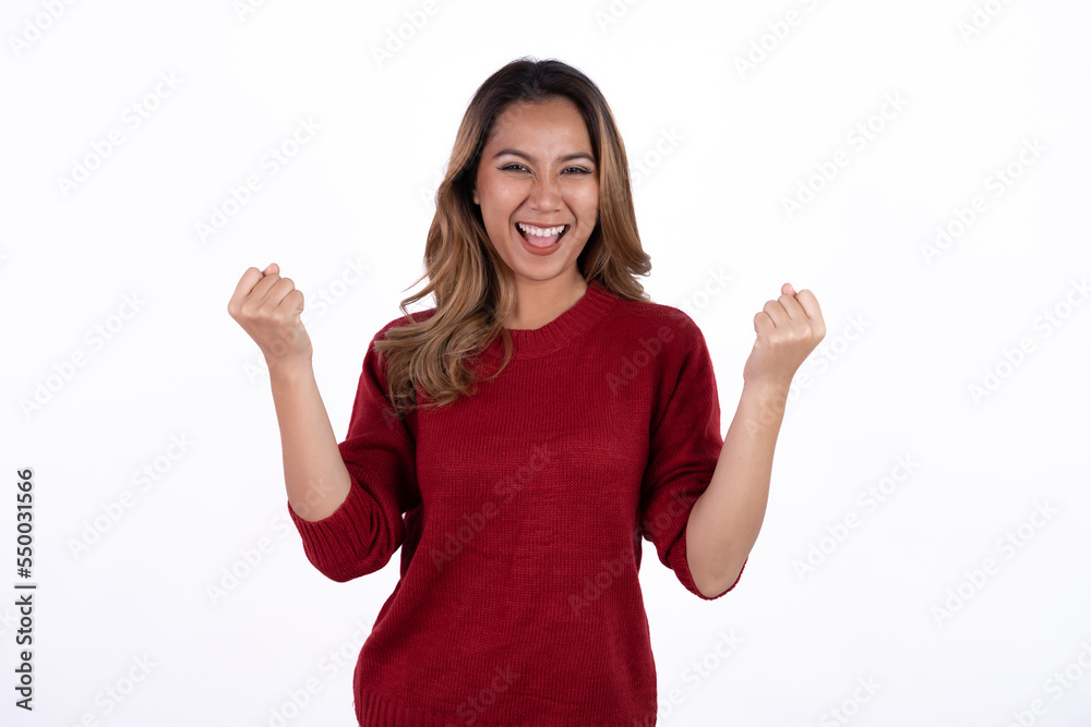 Excited young asian woman with raised hand celebrating success Portrait cheerful positive asian female with raised hands and fists open mouth Girl get happy enjoy life Light white background.