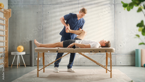 Professional Sport Physiotherapist Working on Specific Muscle Groups or Joints with Young Male Athlete. Sportsman Recovering from Mild Injury. Trauma Prevention Therapy or Rehabilitation.