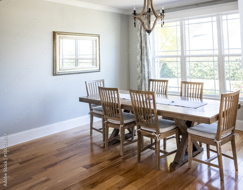 Fototapeta premium An open coastal dining room in a new construction house with hard wood floors