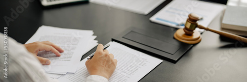 Lawyer with lawsuit meeting with client discussing with contract agreement at courtroom..