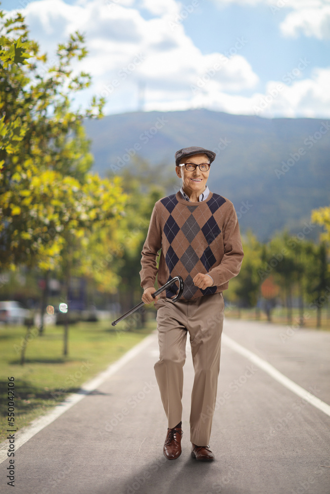 Happy elderly man walking on a pedestrian track Happy elderly man walking on a pedestrian track