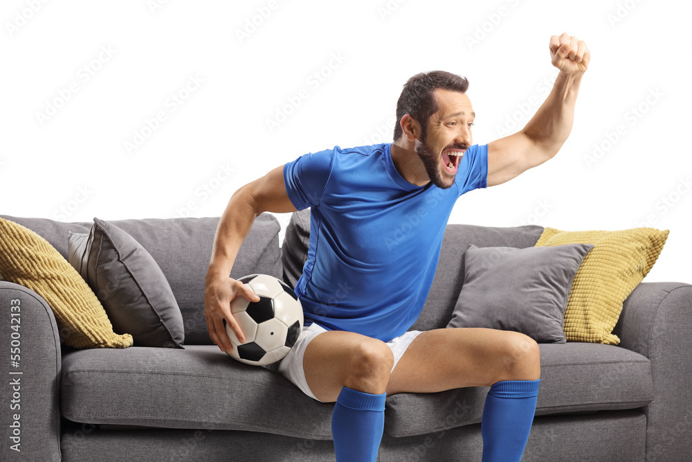 ONWAAR Klimatologische bergen Trouwens Football player sitting on a sofa holding a ball and watching a match Stock  Photo | Adobe Stock