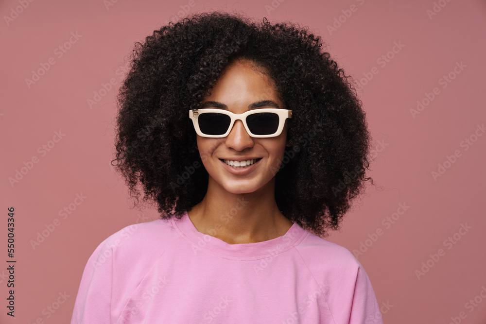 Portrait of young beautiful smiling curly woman in sun glasses Portrait of young beautiful smiling curly woman in sun glasses